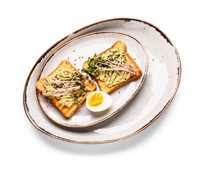 Tasty avocado toasts with micro green and egg on white background