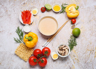 Composition with tasty Thai soup and ingredients on grunge background