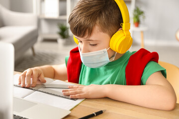 Little boy studying online at home