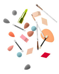 Set of makeup sponges with brushes and lipstick on white background