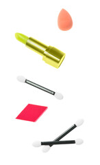 Set of makeup accessories and lipstick on white background
