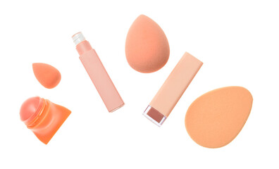 Set of lipsticks with makeup sponges on white background