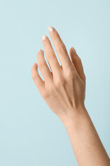 Female hand with beautiful manicure on color background