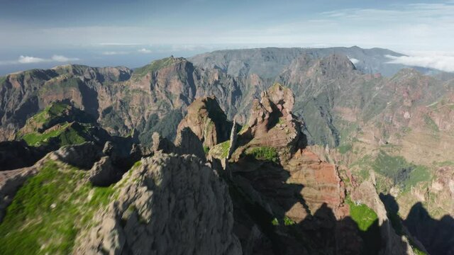 Madeira Islands, Portugal. High peaks covered with endemic plants within cloudy sky. Aerial view of indescribable landscapes as seen from a peak. High quality 4k footage