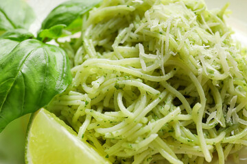 Tasty pesto pasta and lime, closeup