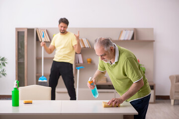 Obraz premium Two male contractors cleaning the house