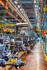 Naklejka premium Heavy Industry Ideas. Modern Tractors Machinery Assembly Line With Manufacturing Infrastructure Facilities Alongside.