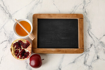 Symbols of Rosh hashanah (Jewish New Year) and empty chalkboard on white background