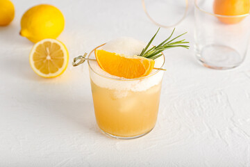 Glass of tasty whiskey sour cocktail on white background