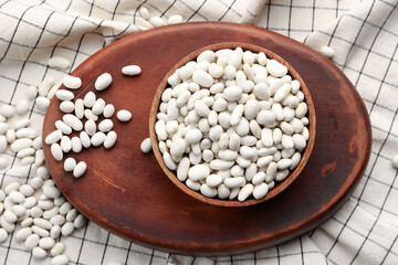 Bowl with raw beans on table