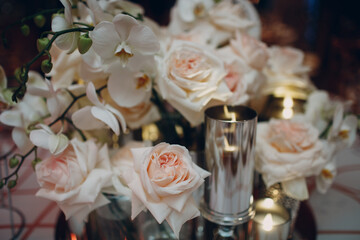 Wedding decor table with white flowers and candles.