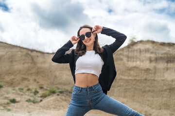 female model in casual cloth walk in sand quarry