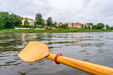 Wooden paddle of a kayak on the Elbe river