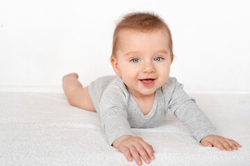 Portrait of a cute baby boy with blue eyes on white background