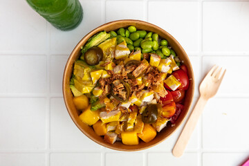 take-away poke bowl with beans, tuna fish, avocado and vegetables, to-go vegetarian bowl 