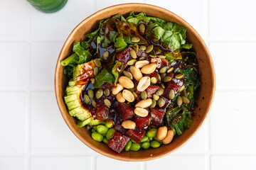 take-away poke bowl with beans, tuna fish, avocado and vegetables, to-go vegetarian bowl 