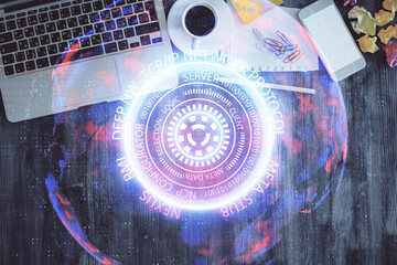 Technology hologram drawing over computer on the desktop background. Top view. Double exposure....
