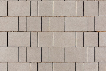 Paving with new rectangular paving slabs. A combination of slabs of different sizes. View from...