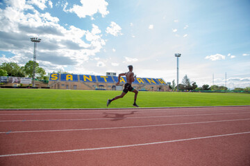 African American muscular young man runner on running track