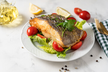 Close up of crispy grilled halibut steak on a plate. Healthy food rich of omega unsaturated fats good for brain health