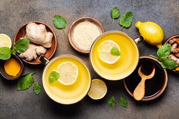 Hot drinks with ginger, lemon and mint in a cups.