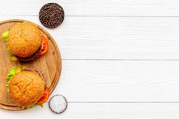 Homemade burgers with ingredients. Fastfood meal background