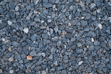 Photo of crushed stone or grey granite gravel background use for background,wallpaper,construction industrial concept.,Abstract close up stone texture.