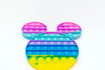 Color sensory pop it antistress toy for children. rainbow toy on white background.Pop it trendy toy.Copy space.