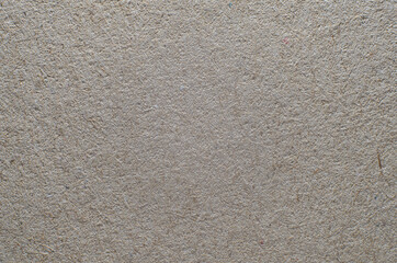 Rough texture of brown paper with fibers, cardboard macro photography. Close-up paper gray background top view