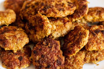 Homemade cutlets,meatballs white plate on a table yellow background.Delicious homemade cutlets.Selective focus.Closeup.