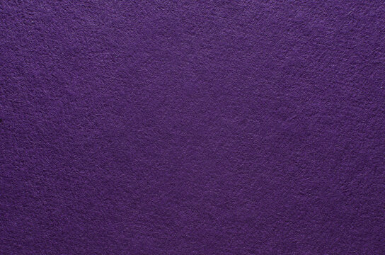 Rough purple paper texture with fibers, macro photography. Close-up paper background top view