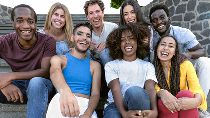 Happy multiracial group of diverse friends hang out in the city - Young people lifestyle concept