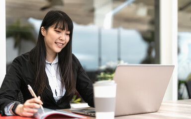 Business Asian woman working on laptop in cafe shop - Youth entrepreneur concept