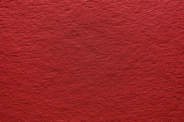 Rough texture of red paper with fibers, macro photography. Close-up paper background top view