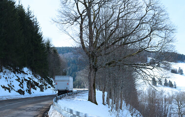 Truck on mountain road in winter (Black Forest, Germany)