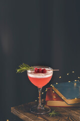 Elegant glass of raspberry cocktail with egg, decoration fresh berries on rosemary branch. Club cocktail. Sour drink with gin, raspberries, and egg white foam