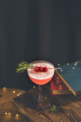 Elegant glass of raspberry cocktail with egg, decoration fresh berries on rosemary branch. Club...