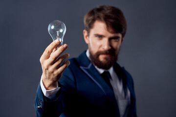business man in a suit with a lamp in his hands creativity