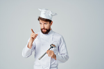 chef with saucepan in hands in kitchen restaurant food preparation service