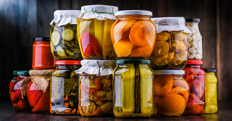 Jars with variety of marinated vegetables and fruits