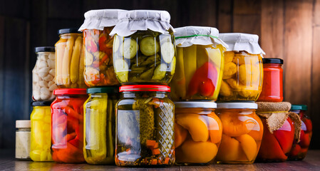 Jars with variety of marinated vegetables and fruits