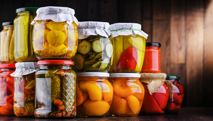 Jars with variety of marinated vegetables and fruits