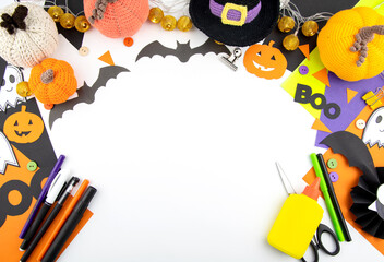 Halloween background top view of children's crafts, colored paper around the edges. Space for copying in the center.