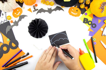 Instructions for making paper bat crafts with children. Step 5.