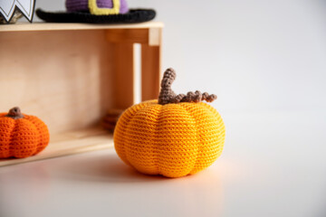 Crocheted orange pumpkin for autumn home decor.