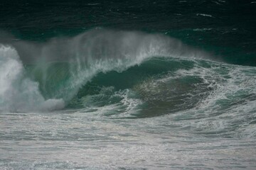 Naklejka premium wave breaking on the beach during a big storm