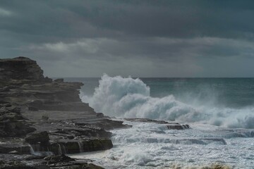waves crashing on rocks/ cliffs during a bog storm