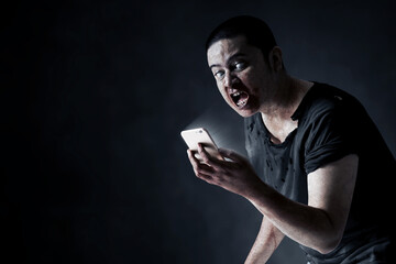 Scary zombie using a smartphone
