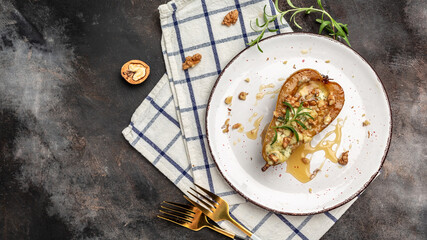 Homemade baked pears with blue cheese, gorgonzola, roquefort honey and walnuts. Restaurant menu, dieting, cookbook recipe