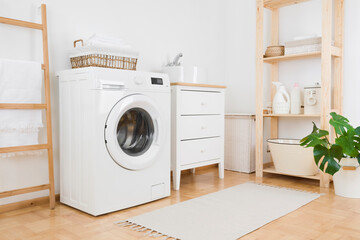 Washing machine in vintage laundry room interior with wooden furniture - obrazy, fototapety, plakaty